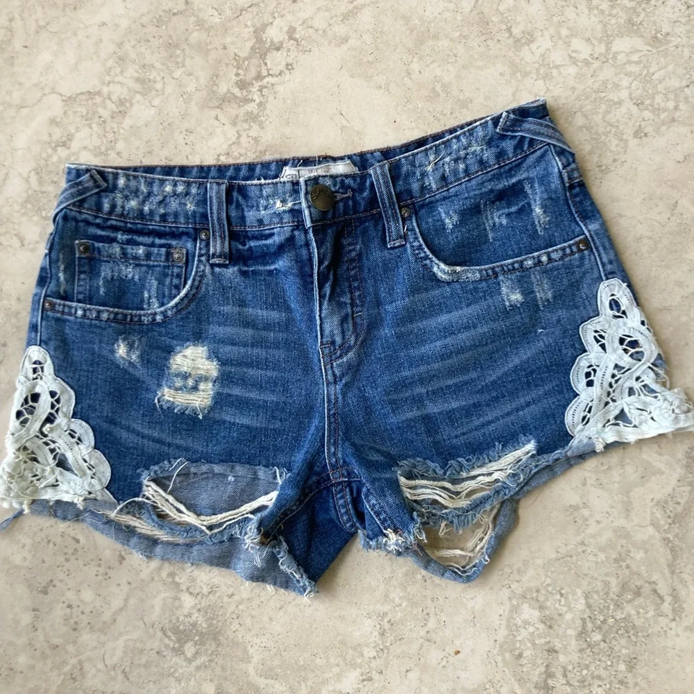 Free People Distressed Blue Denim Shorts with Lace Accents